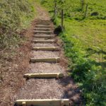 Photo showing work underway putting in the wood planks that will be back filled to make the new steps.