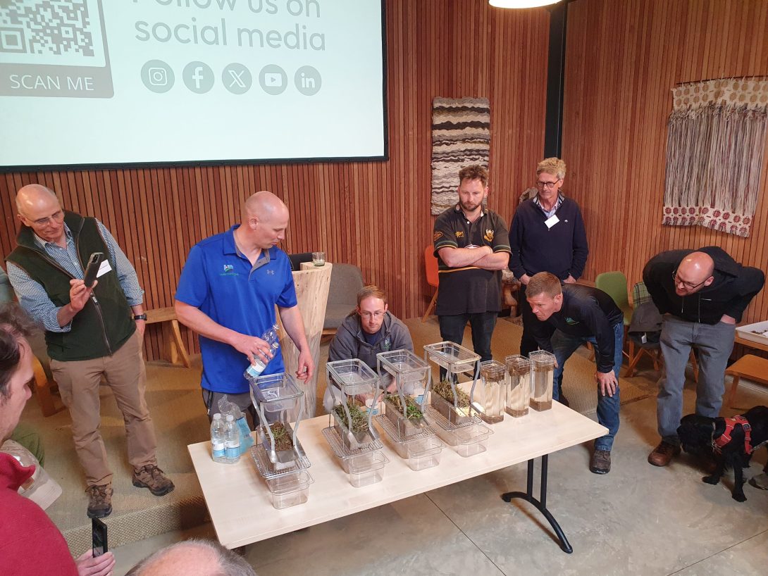 Images shows a group of people taking part in a mobile soil laboratory session.
